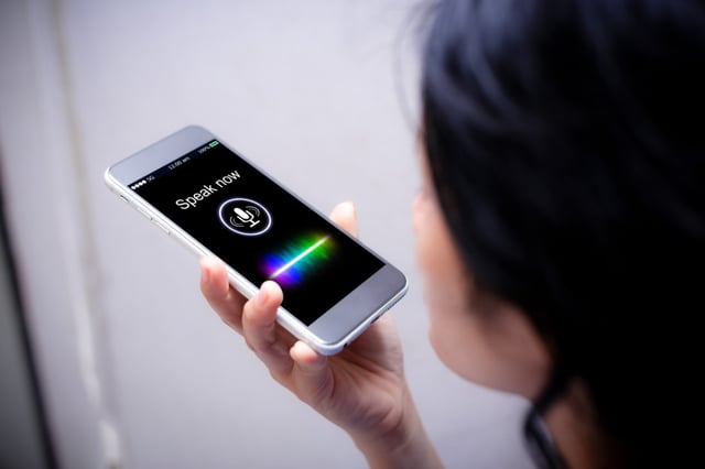 Voice recognition,search technology concept.Close-up of woman talking on her mobile phone