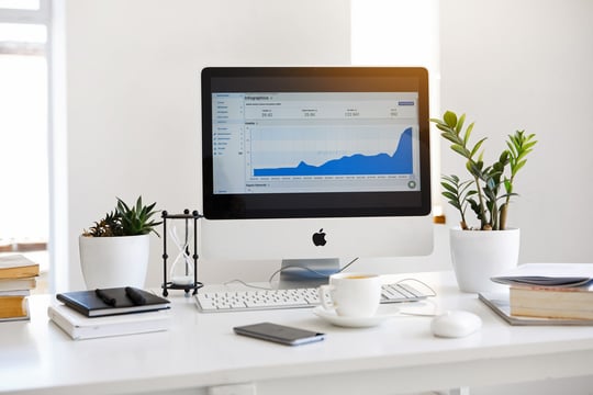 Photo of Google and SEO data on a computer screen that is sitting on a desktop.