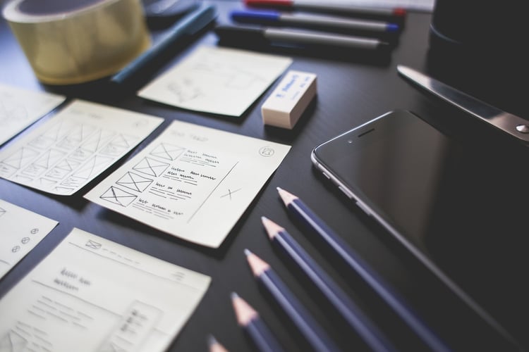 Sketches and tools for mobile app user experience design on a desk