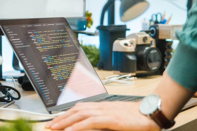 looking at code on a computer with hand in foreground