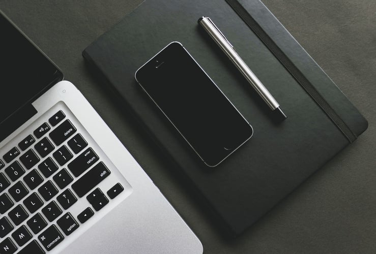 Laptop, pen, and a smartphone