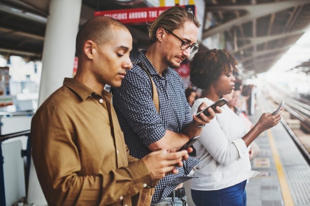 people looking down at their phones