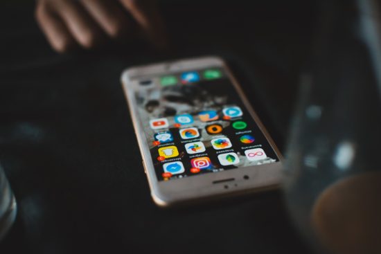 Smartphone with the home screen and apps on display