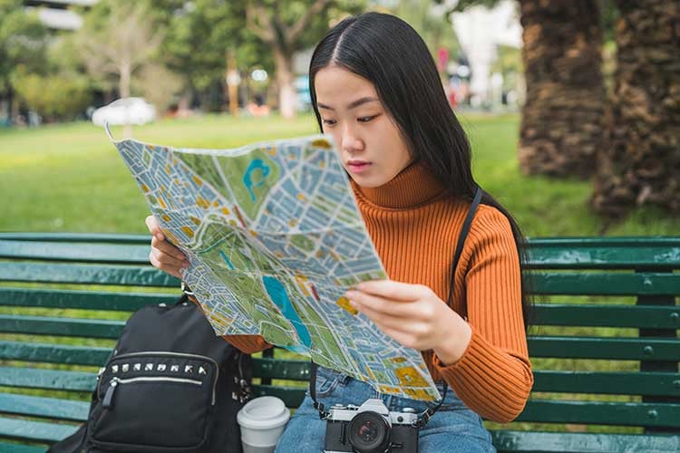 asian-woman-looking-at-a-map-2022-02-01-22-38-40-utc