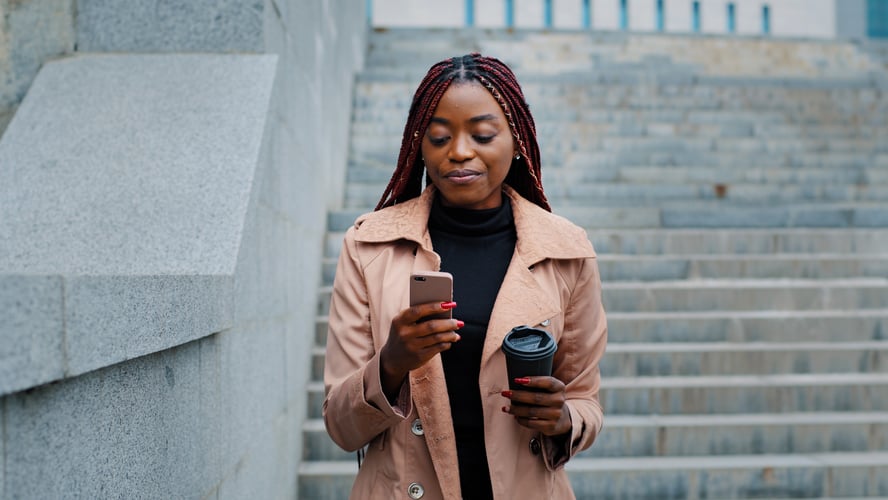 Background image of Close-up young happy woman standing in autumn park communicates video chat on smartphone friendly