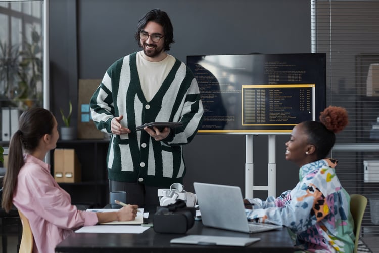 Background image of Developer presenting his report to colleagues