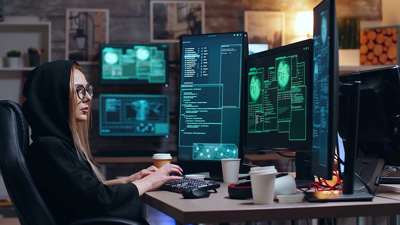 female-hacker-wearing-a-hoodie-using-a-dangerous-v-2022-02-02-04-50-59-utc