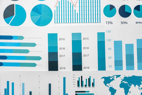Background image of Financial paper with charts and diagrams on gray table