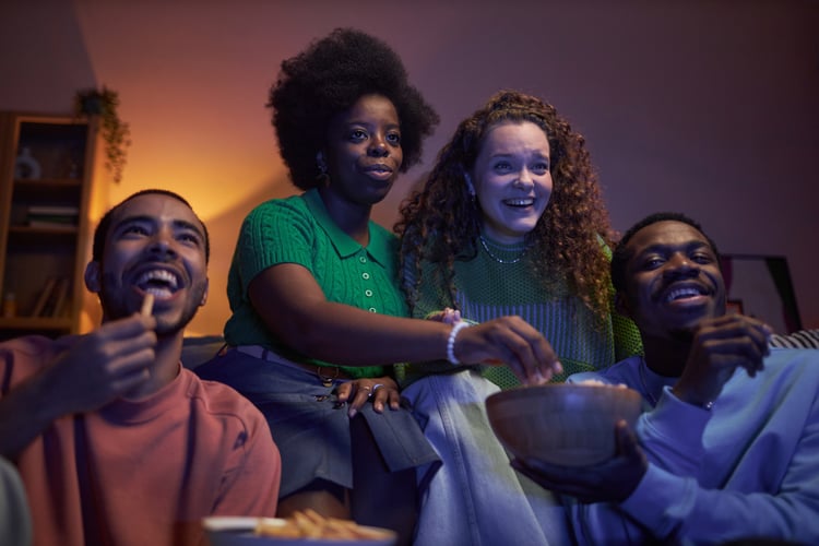 Background image of Group of excited young people watching TV
