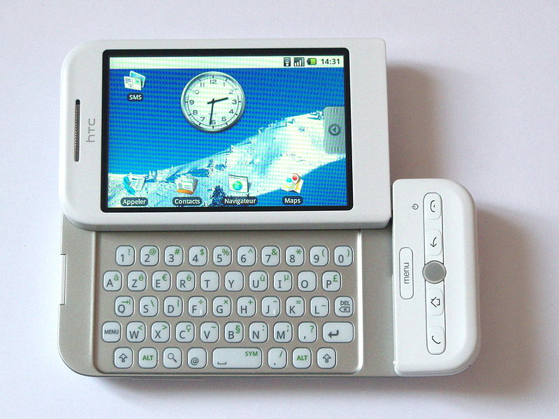 HTC Dream smartphone with its slide-out keyboard open, shown in the French AZERTY layout