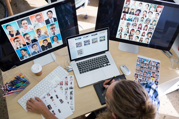 Background image of Male executive working over laptop and graphic tablet at his desk