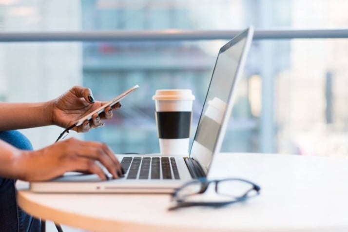 person-using-macbook-air-on-table-1181248-1-716x477