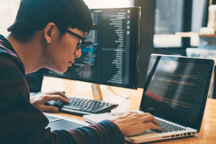 Programmer working on design and development for custom software