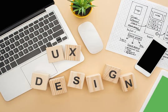 Photo of desktop with building blocks spelling UX Design