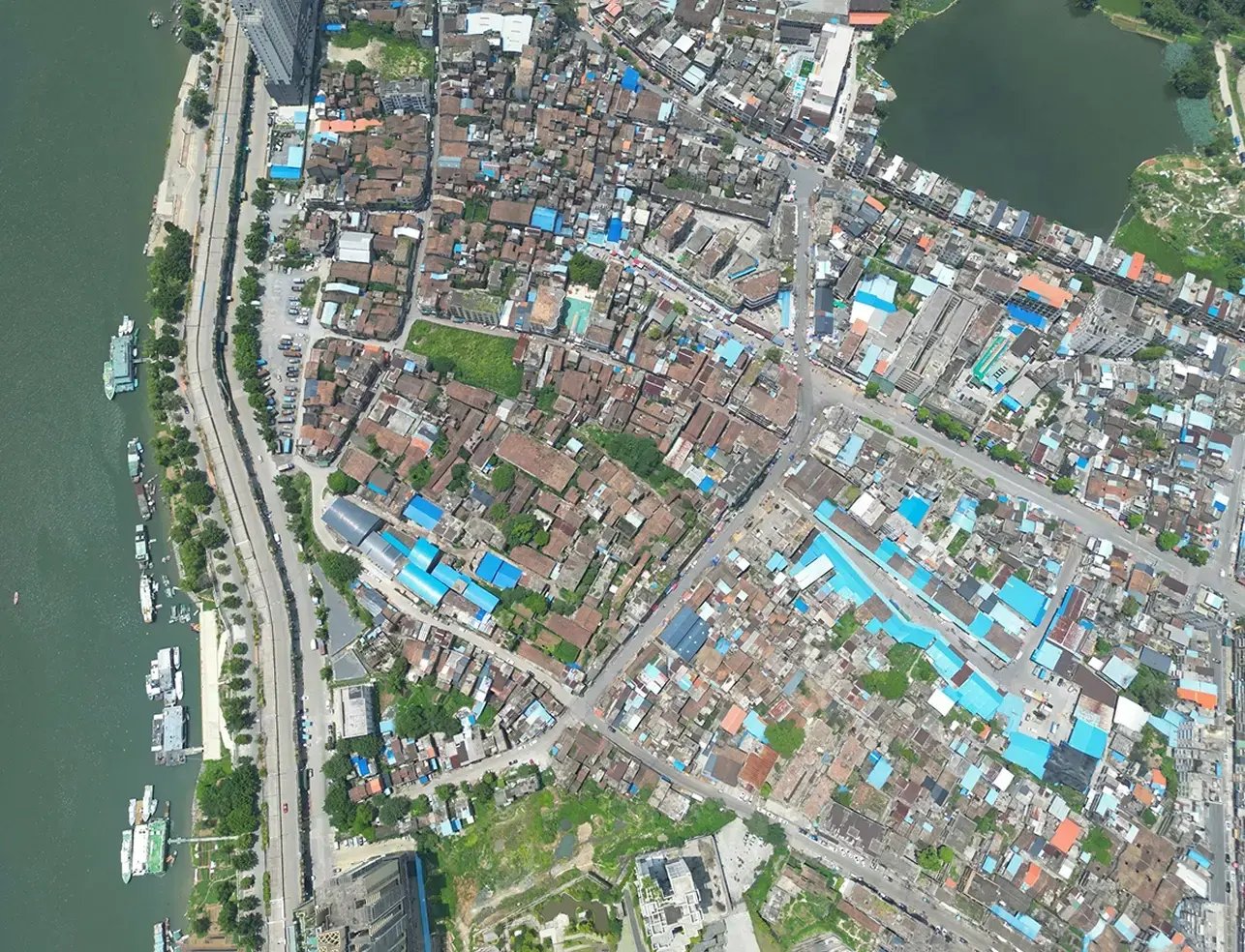 Overhead view of a city and its roof tops.