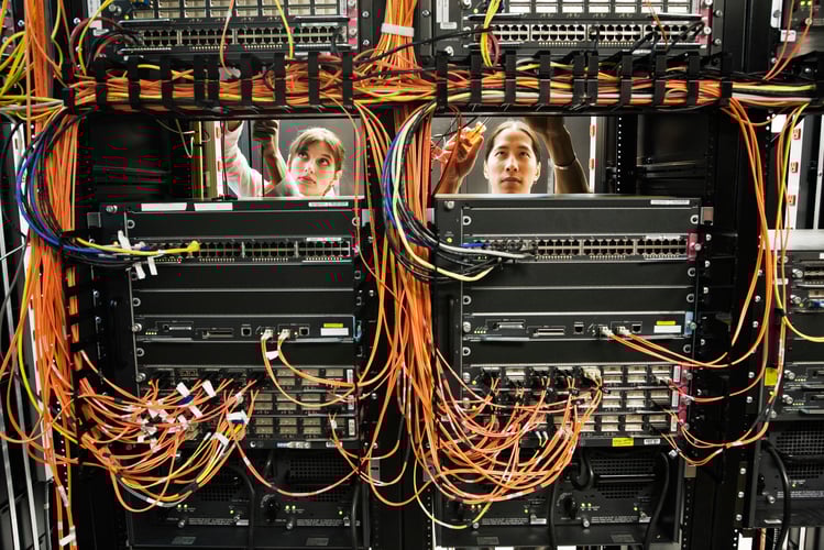 Background image of technicians working on a CAT 5 cable bundling system in a server room