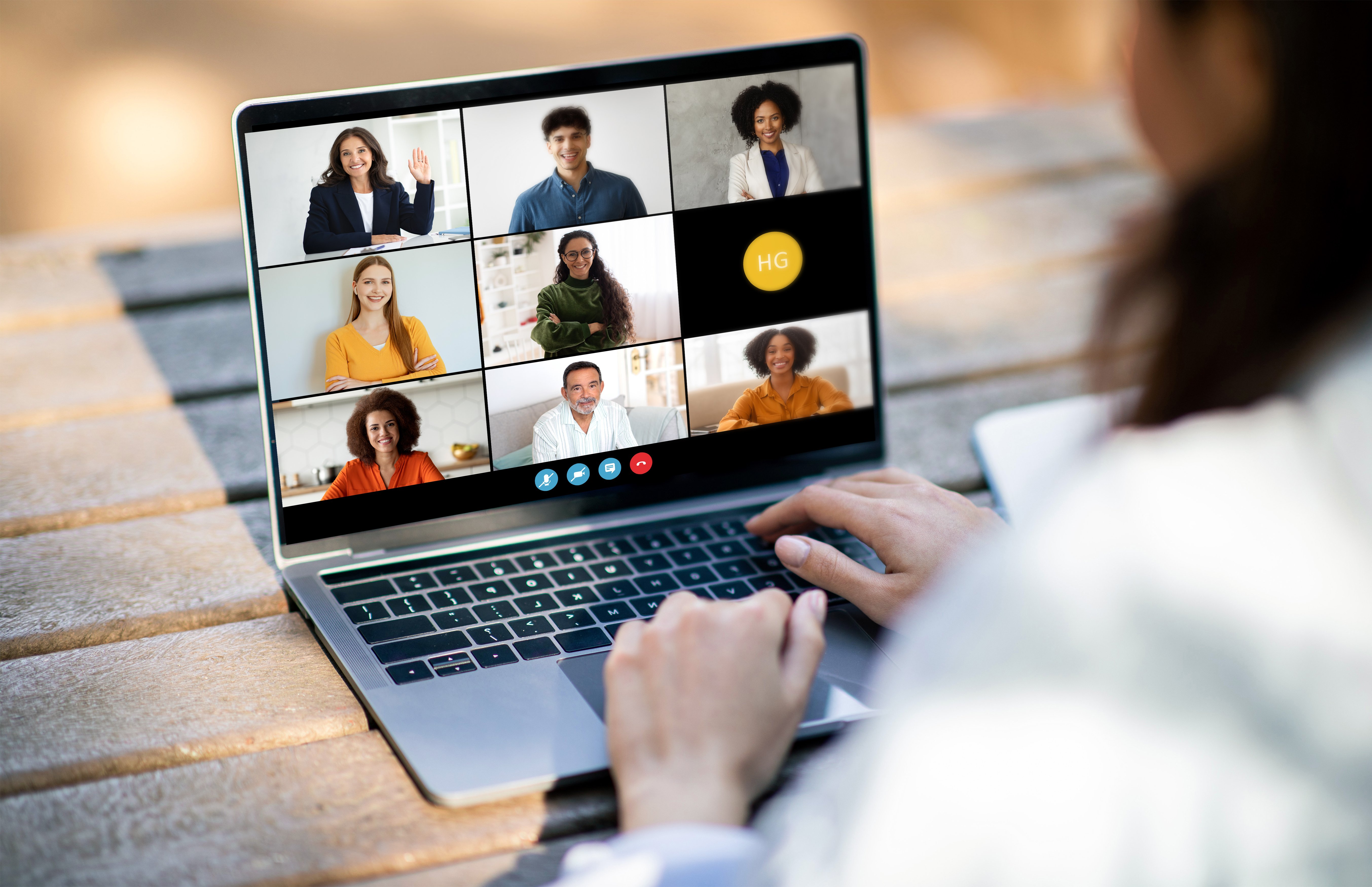 unrecognizable-woman-using-laptop-with-group-of-pe-2025-03-18-17-56-11-utc