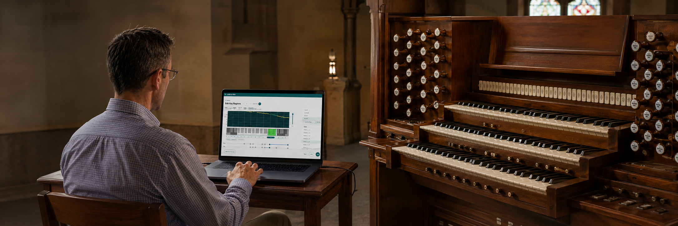 Organ voicing specialist using LARK by Allen on a laptop beside a multi-manual organ console.